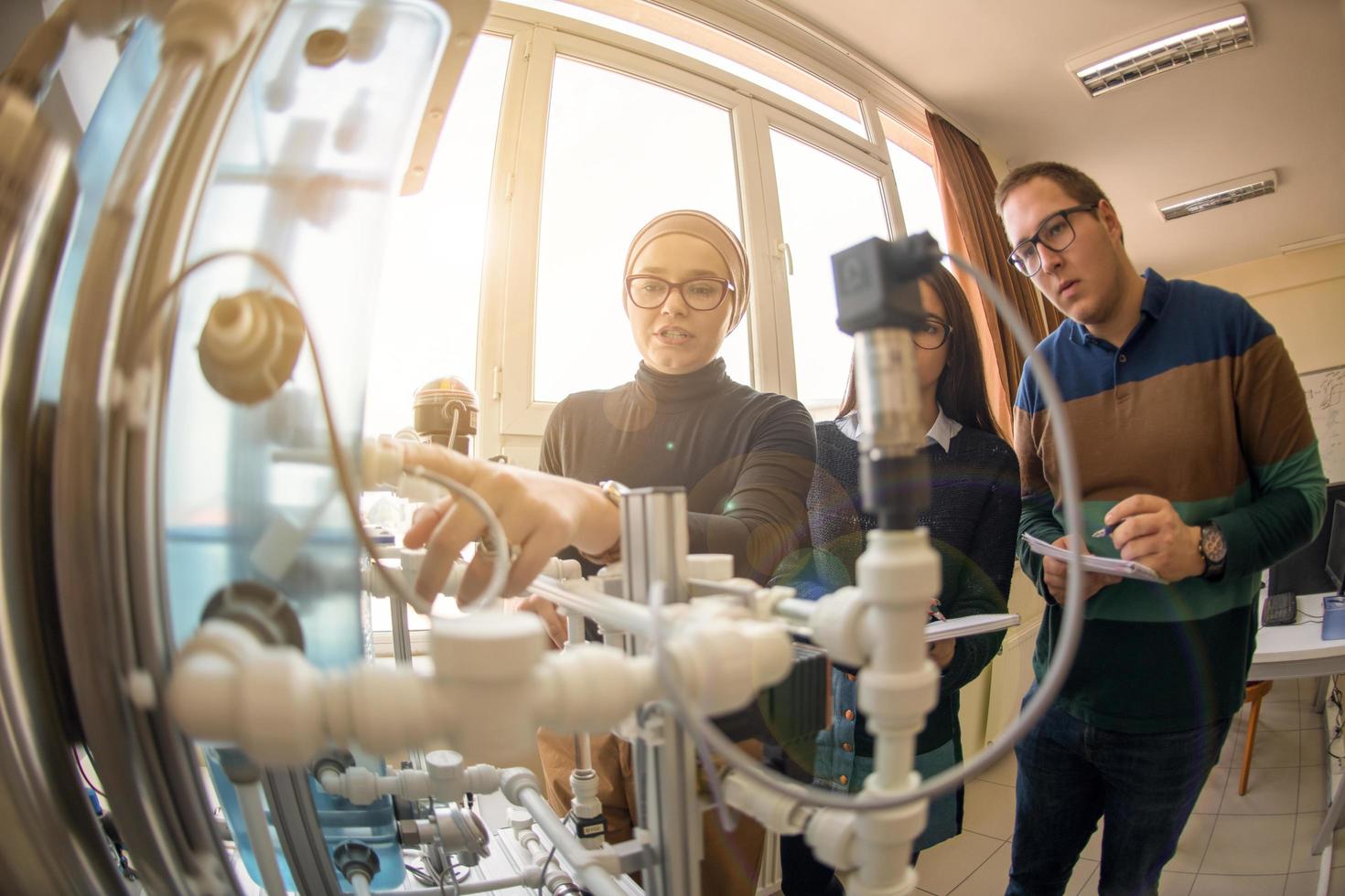 ung studenter håller på med öva i de elektronisk klassrum foto