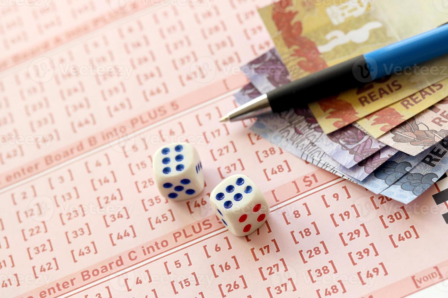 tärningar kuber med brasiliansk pengar räkningar på tom av lotteri spel. begrepp av tur och hasardspel i Brasilien foto