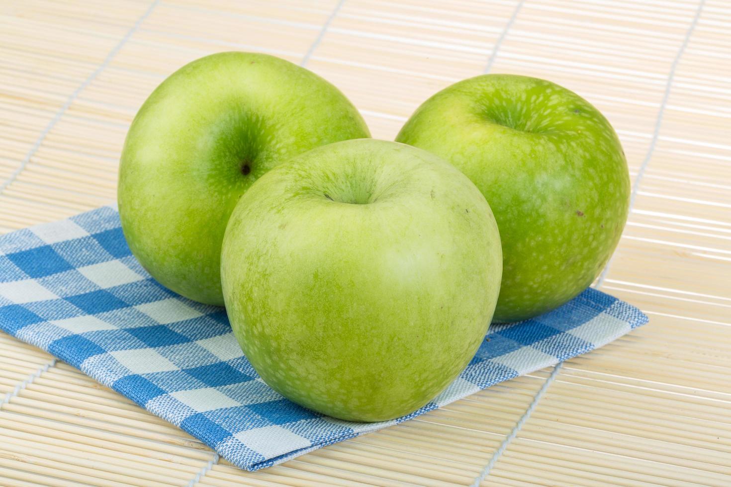 grönt äpple på trä foto