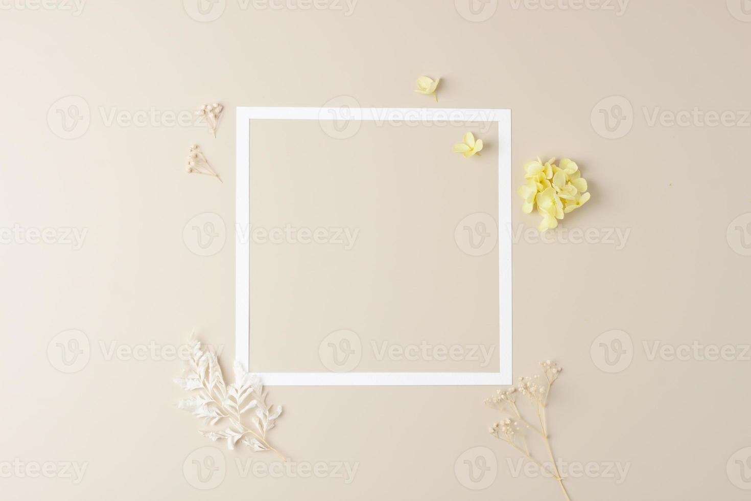 kosmetisk bakgrund med blommor och vit ram på pastell beige. platt lägga, kopia Plats foto