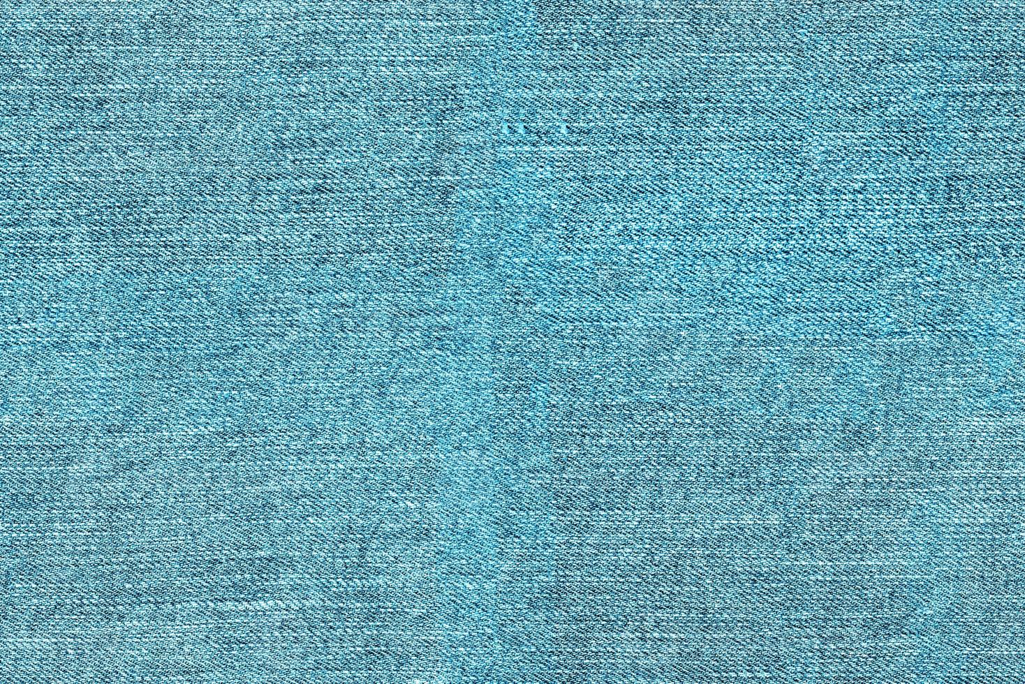 sömlös textur bakgrund av ljus blå denim tyg foto