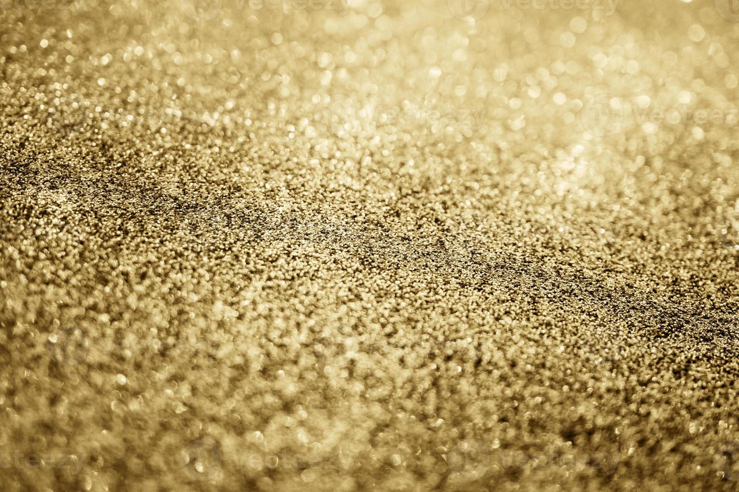 abstrakt guld glitter gnistra med bokeh bakgrund foto