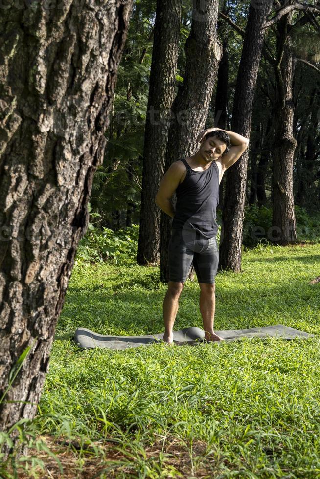 ung man, håller på med yoga eller reiki, i de skog mycket grön vegetation, i Mexiko, guadalajara, bosque colomos, latinamerikan, foto