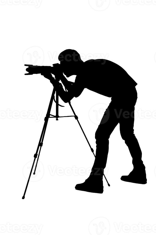 fotograf skytte. sida se silhuett av man använder sig av stativ medan skytte och stående isolerat på vit foto