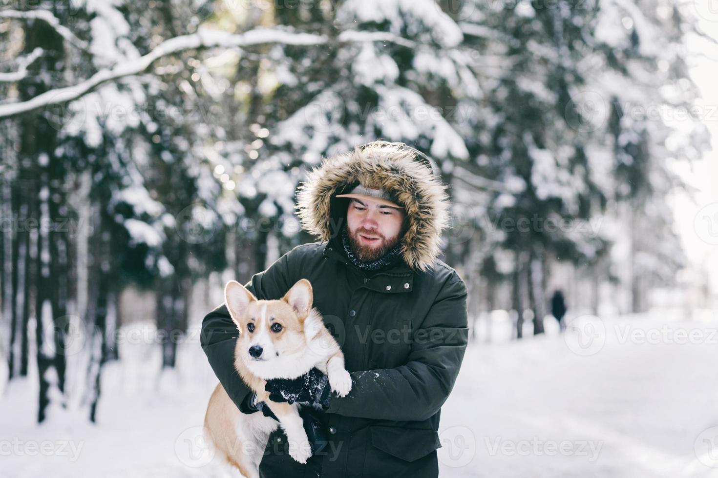 man i vinter- jacka gående hans hund foto