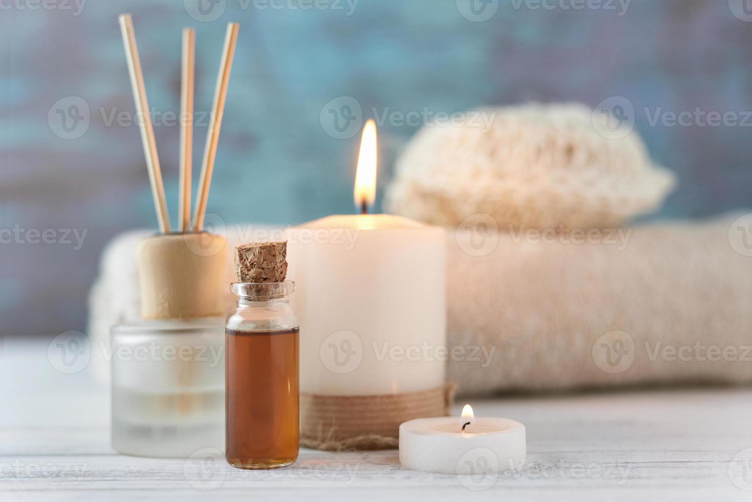 handdukar, ljus och massage olja på vit tabell foto