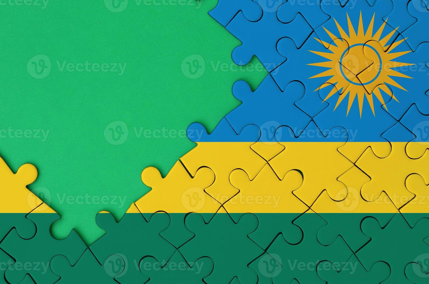 rwanda flagga är avbildad på en avslutad kontursåg pussel med fri grön kopia Plats på de vänster sida foto