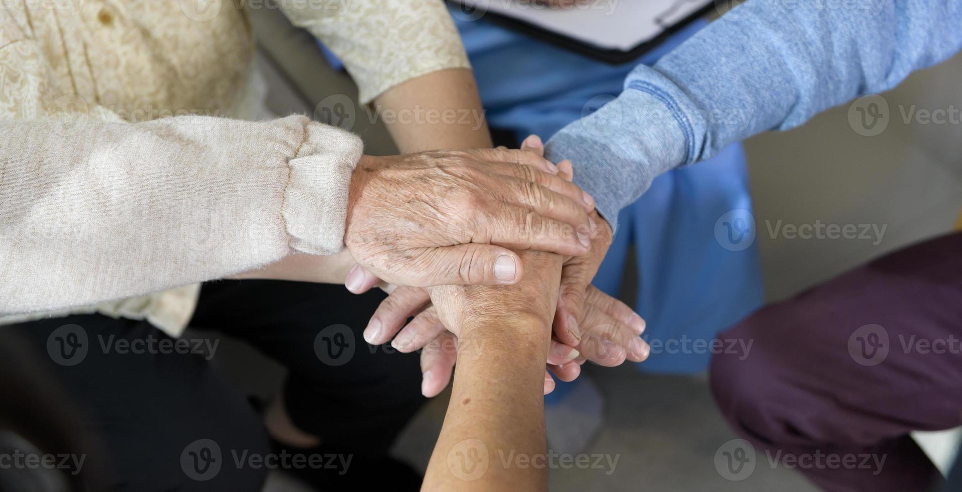 topp se av seniors människor innehav händer tillsammans i äldre hälsa vård Centrum , begrepp av gammal människor hälsa vård , grupp terapi . foto