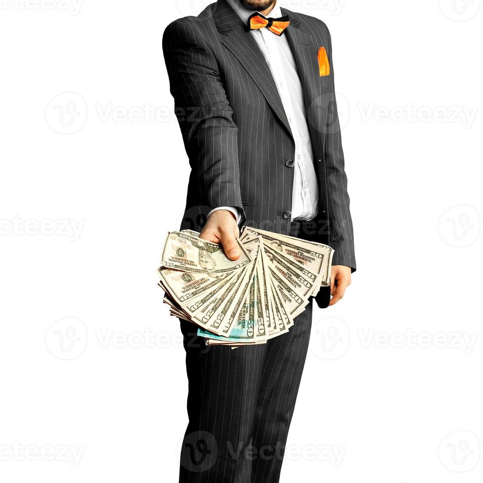 kille i ett elegant kostym med en knippa av pengar i de händer foto