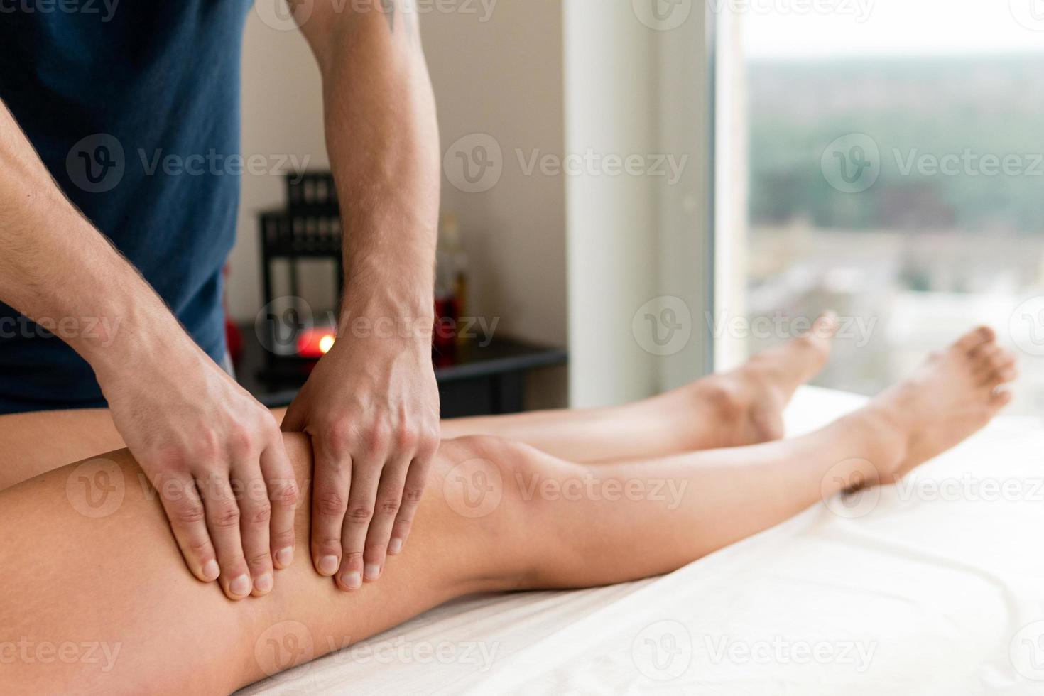 manuell terapeut arbetssätt med en klient under ben massage foto