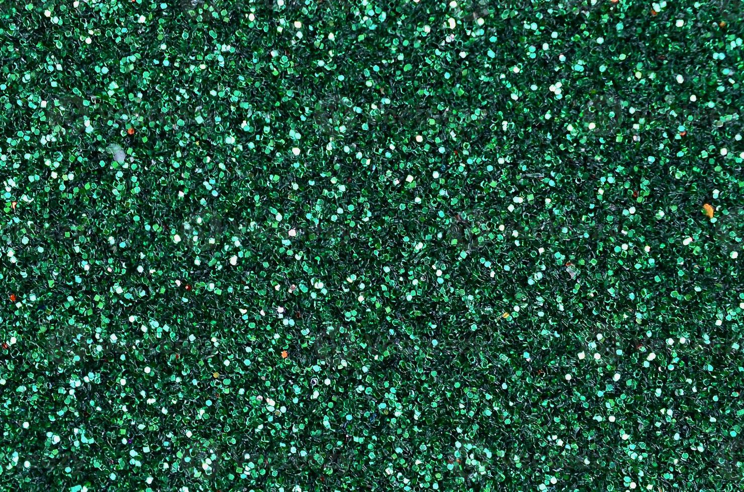 färgrik defocused smaragd- grön bakgrund med glittrande och gnistrande fläckar foto