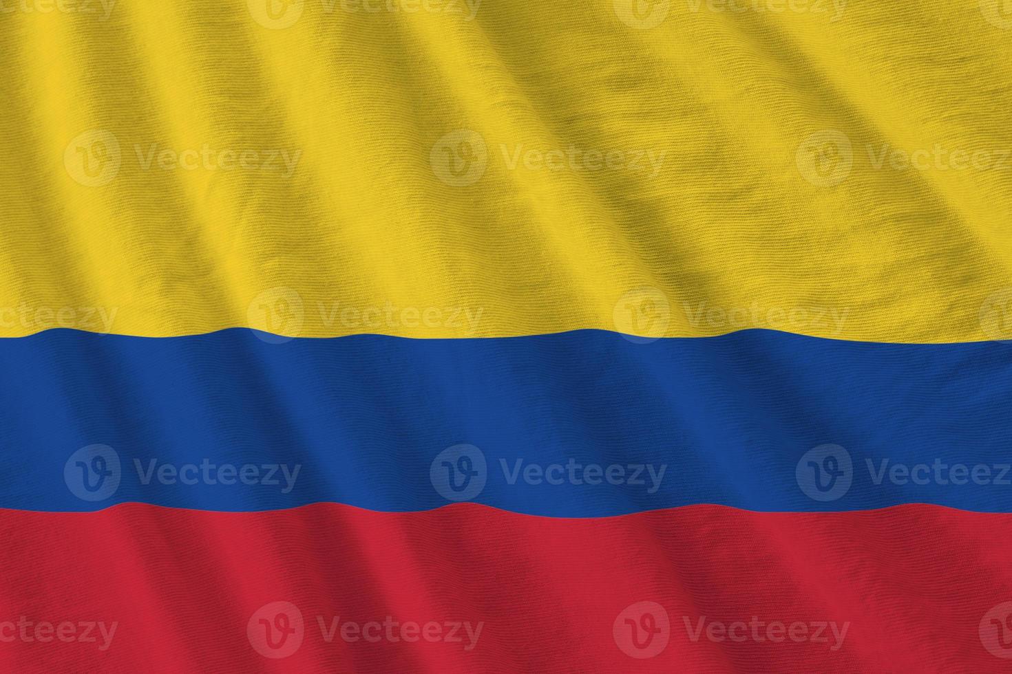 colombia flagga med stor veck vinka stänga upp under de studio ljus inomhus. de officiell symboler och färger i baner foto