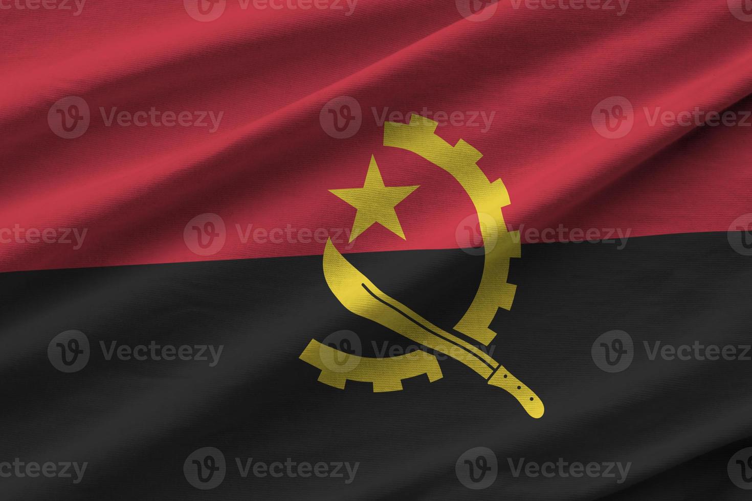 angola flagga med stor veck vinka stänga upp under de studio ljus inomhus. de officiell symboler och färger i baner foto