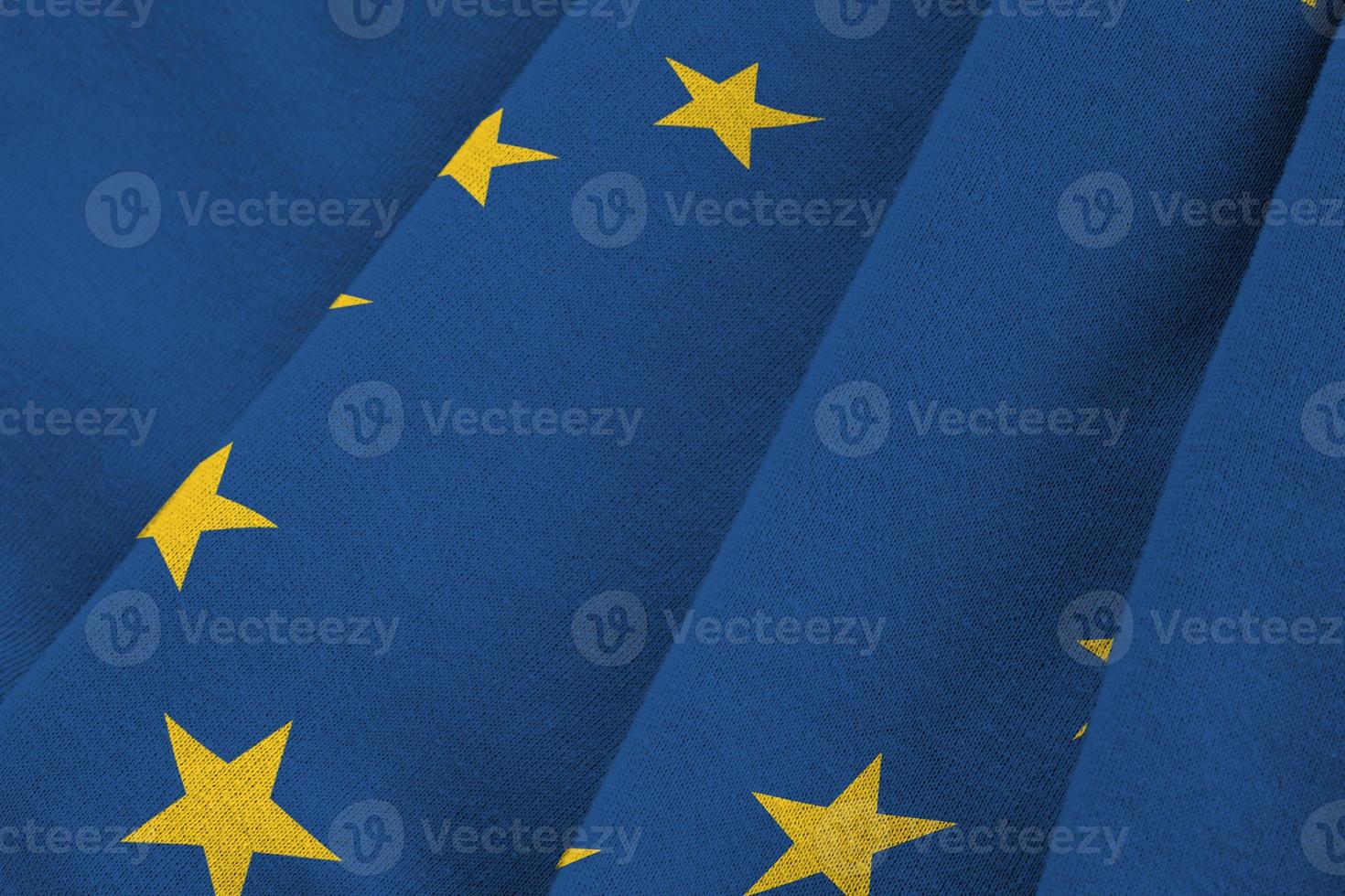 europeisk union flagga med stor veck vinka stänga upp under de studio ljus inomhus. de officiell symboler och färger i baner foto