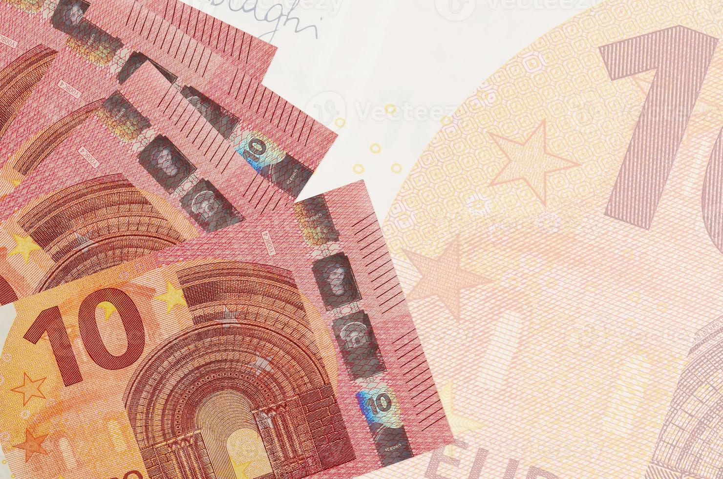 10 euro räkningar lögner i stack på bakgrund av stor halvtransparent sedel. abstrakt företag bakgrund foto