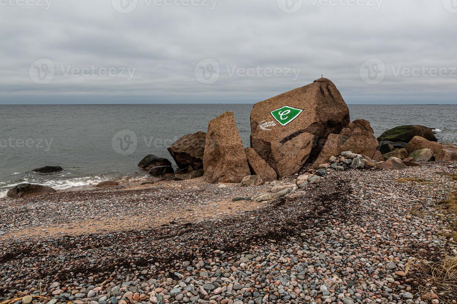 baltic hav kust med småsten och is på solnedgång foto