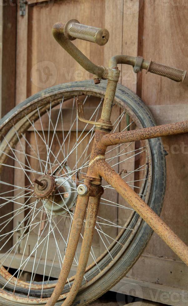 gammal oanvänd cykel hjul lagrat i de tillbaka av de hus, endast de tråd och hjul nav i de lagring rum med gammal styrelse golv som de tillbaka foto