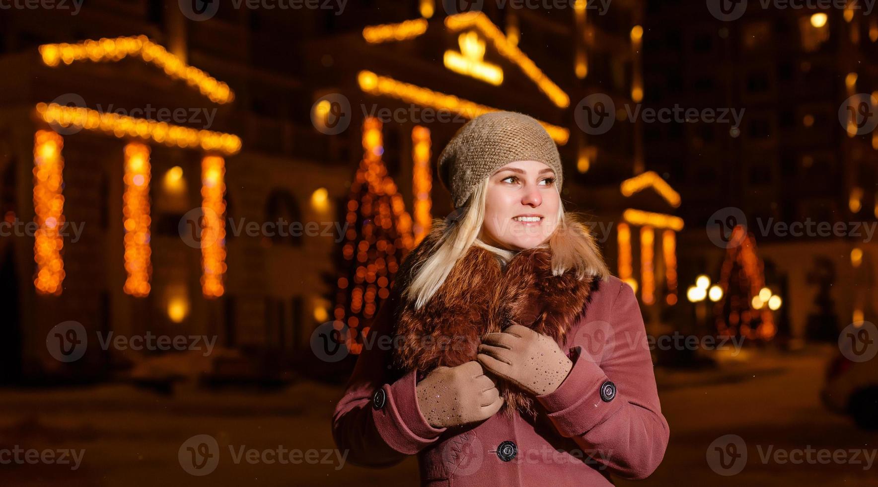 leende vinter- kvinna i natt stad foto