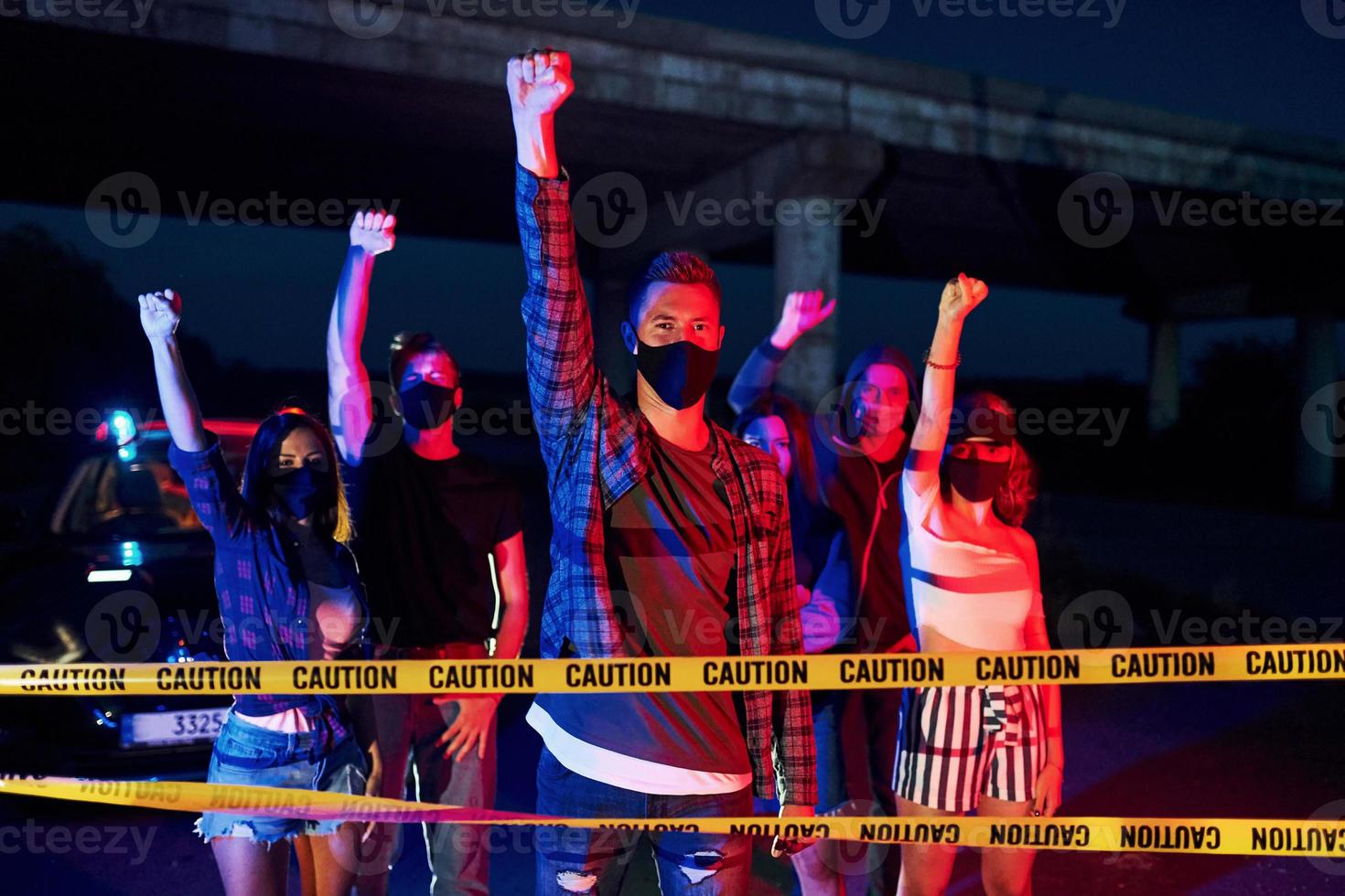 röd och blå polis belysning. grupp av protesterar ung människor den där stående tillsammans. aktivist för mänsklig rättigheter eller mot regering foto