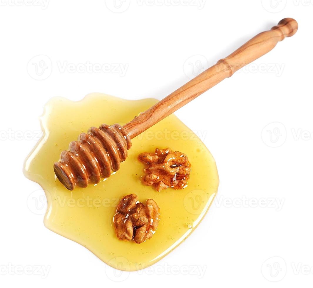 honung dipper med valnötter foto