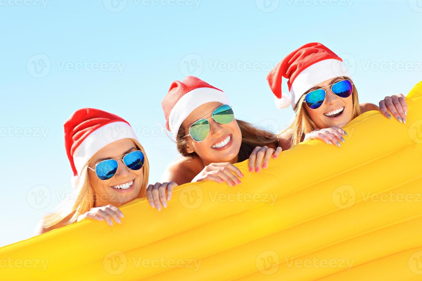 grupp av flickor i jultomten hattar har roligt på de strand foto