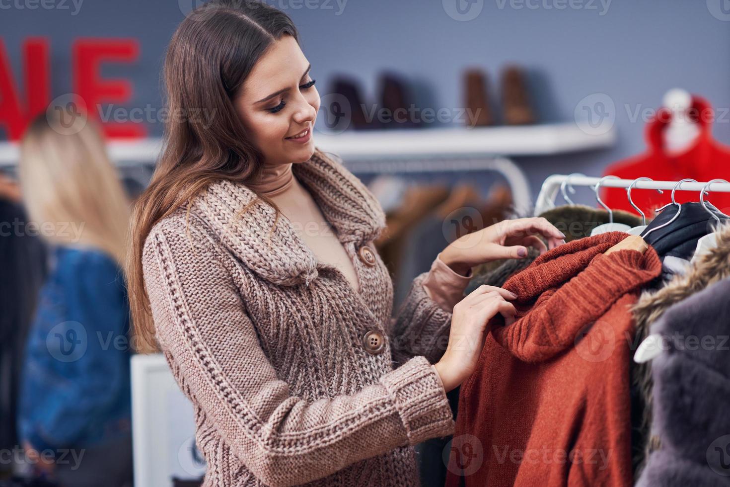 vuxen kvinnor handla för kläder i boutique i höst foto