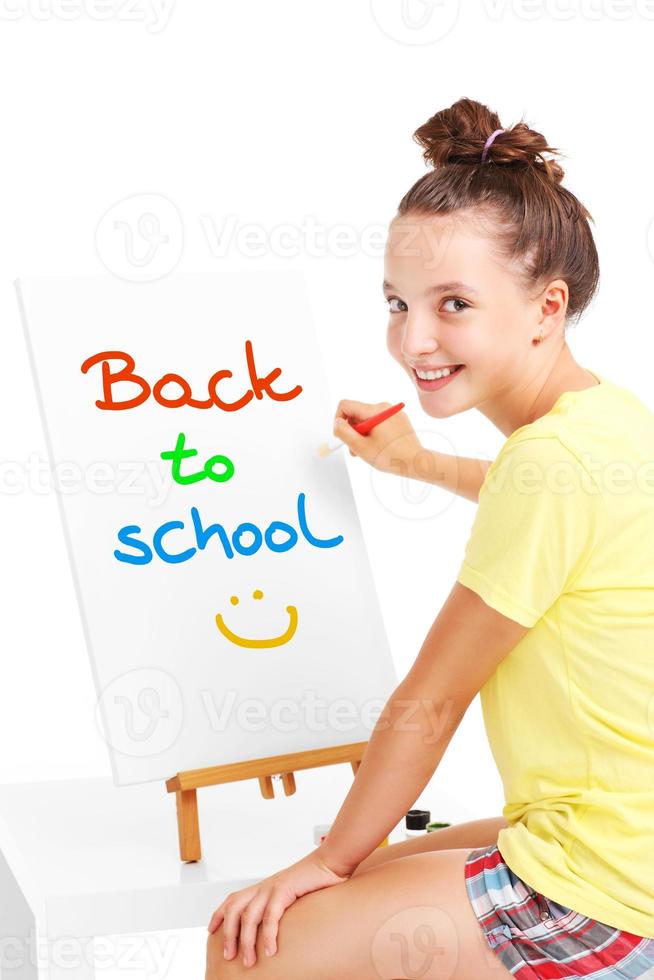 ung flicka målning tillbaka till skola på ett staffli foto