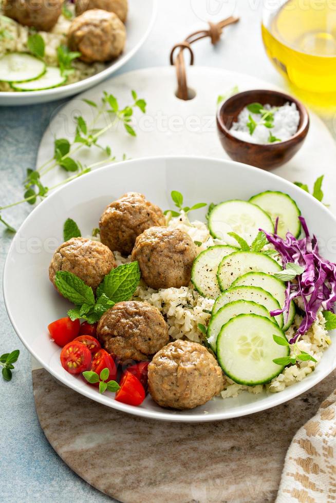 friska lunch skål med köttbullar och blomkål ris foto