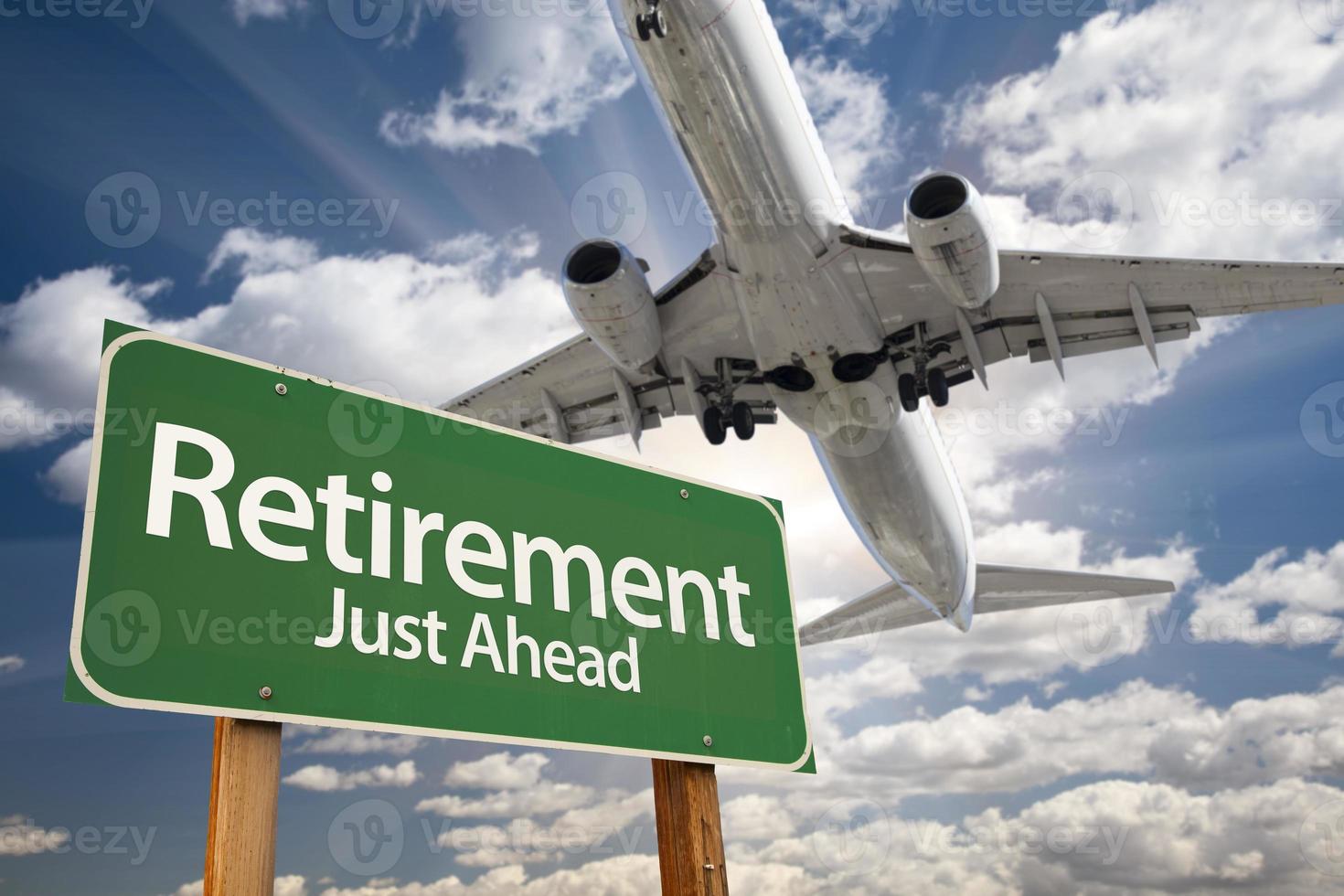pensionering grön väg tecken och flygplan ovan foto