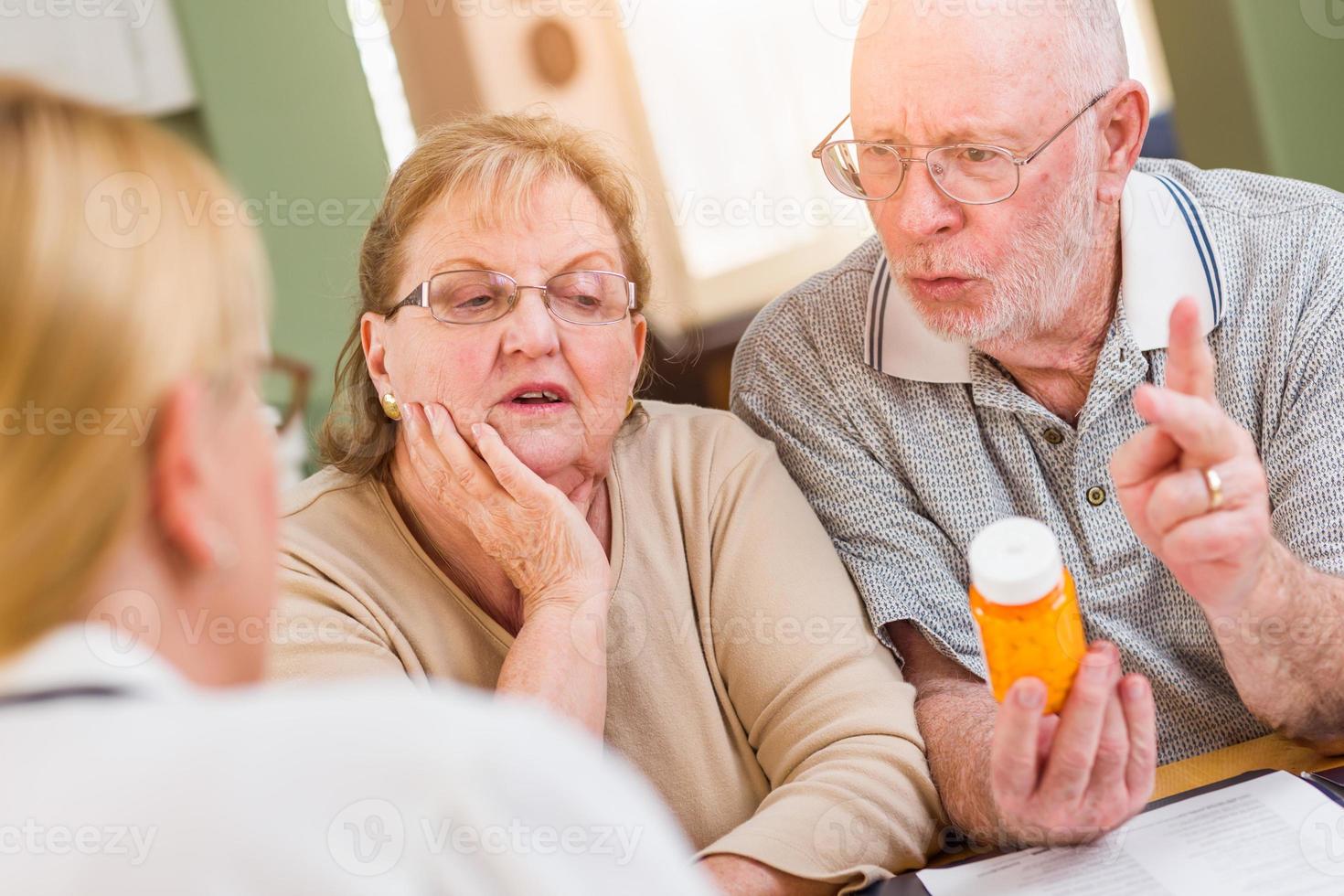 läkare eller sjuksköterska förklara recept medicin till senior vuxen par foto