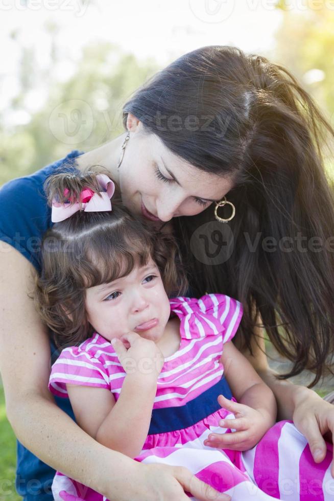 kärleksfull mor konsoler gråt bebis dotter foto