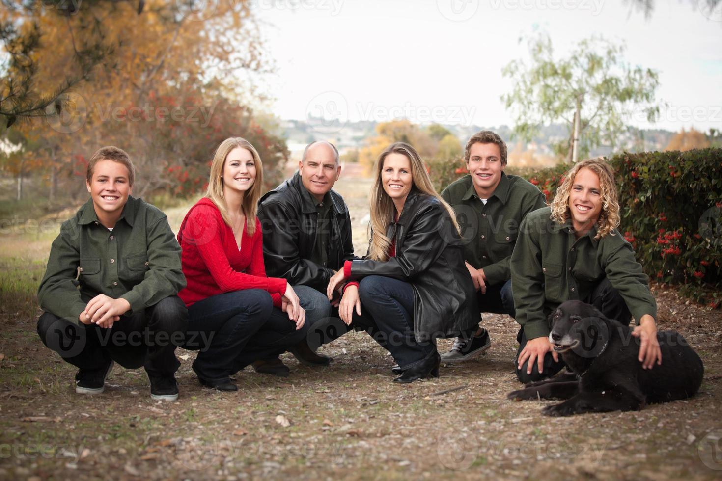 attraktiv familj utgör för en porträtt utomhus foto