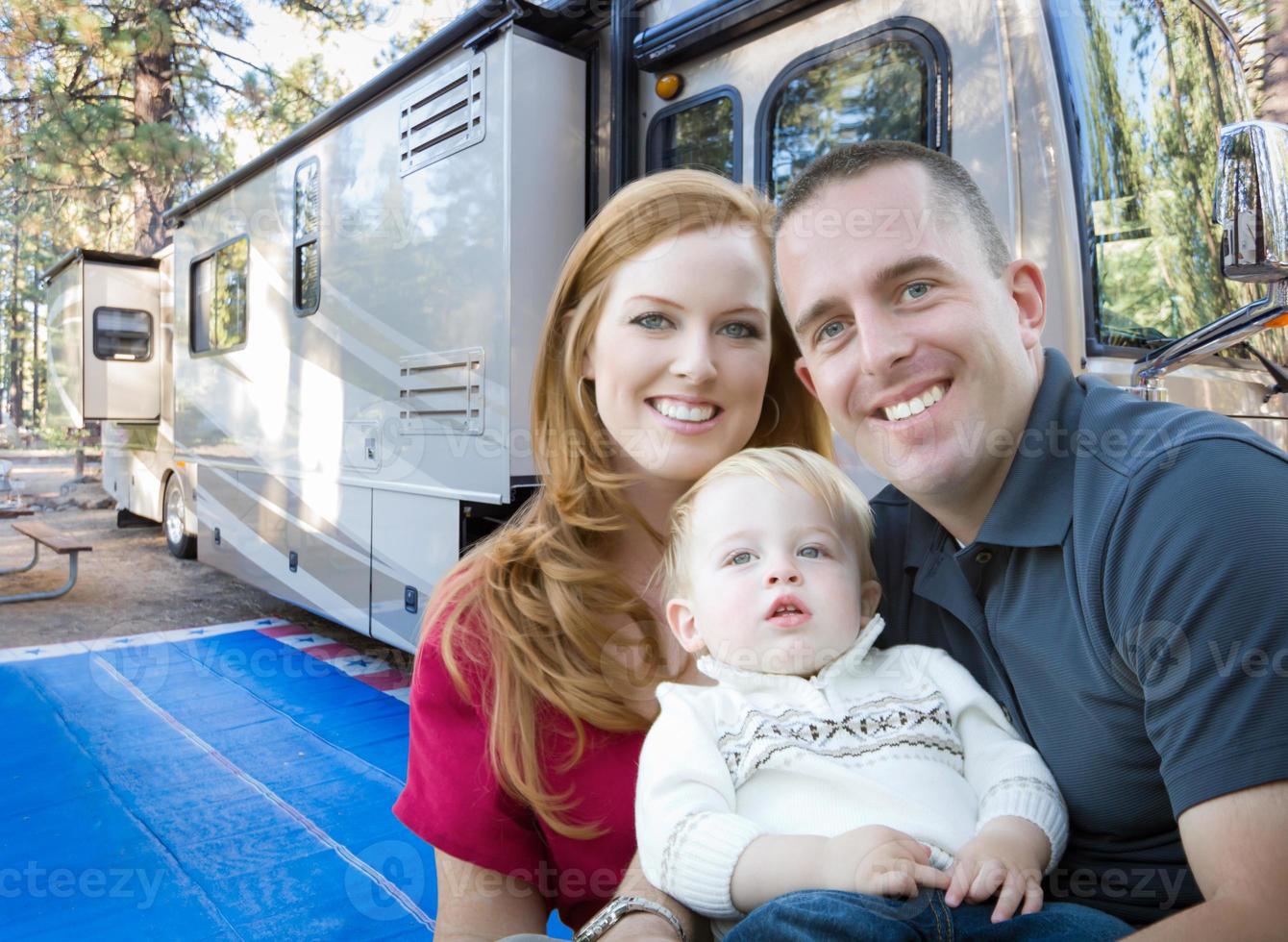 Lycklig ung militär familj i främre av deras skön rv på de campingplats. foto