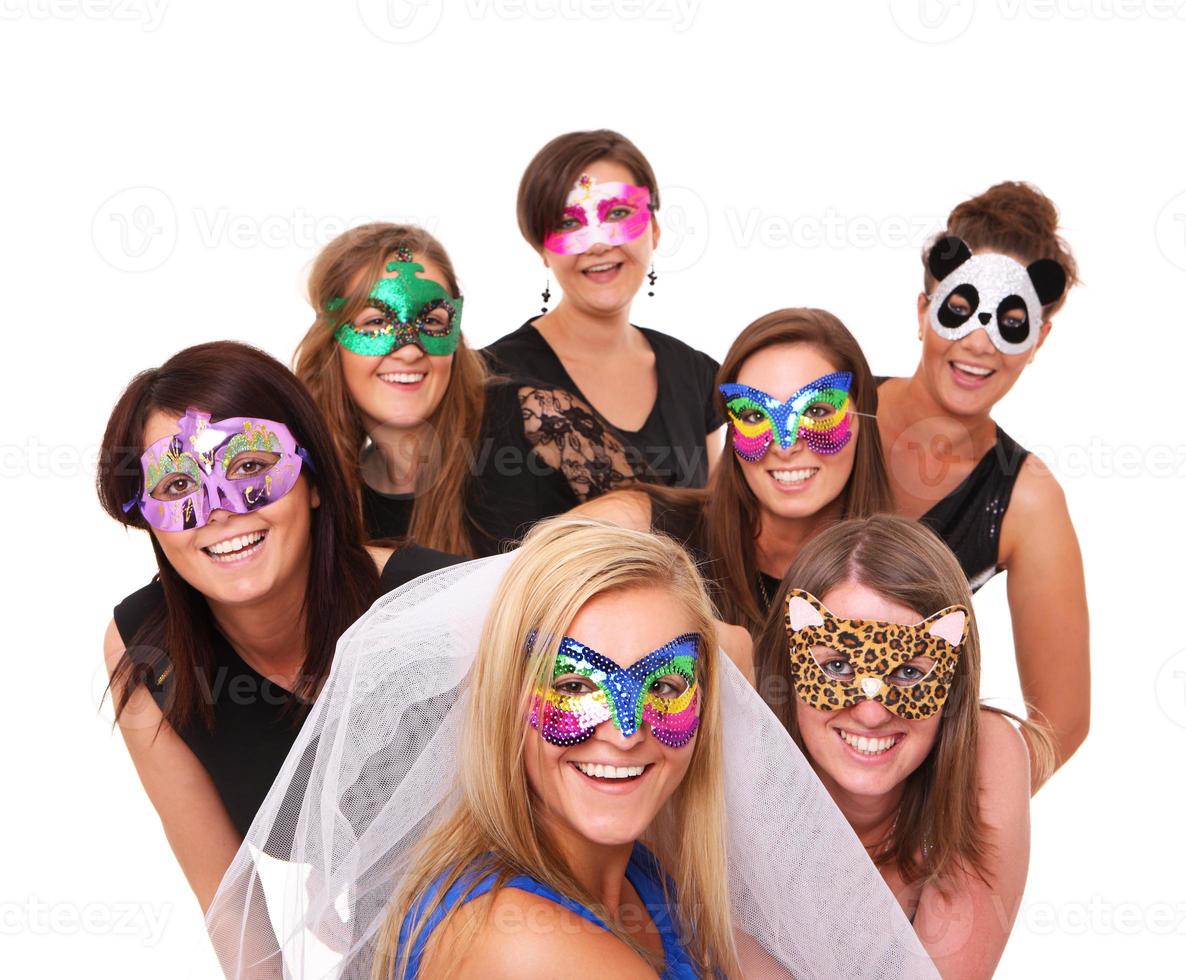 flickor festa med masker foto