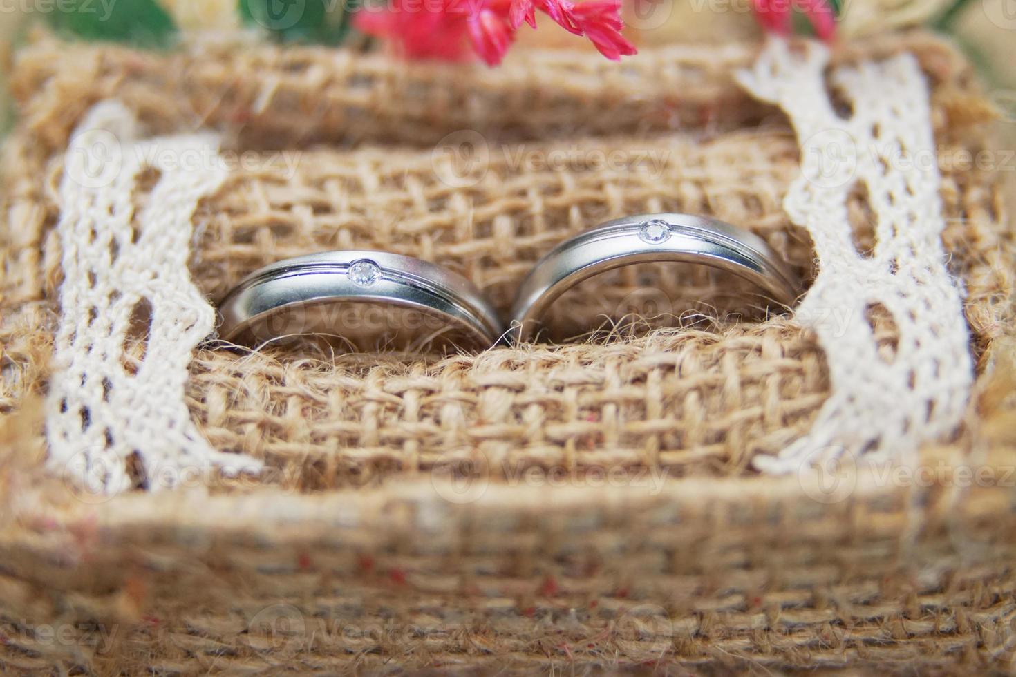 bild av en par av bröllop ringar i en vävd säckväv ringa låda, stänga upp foto