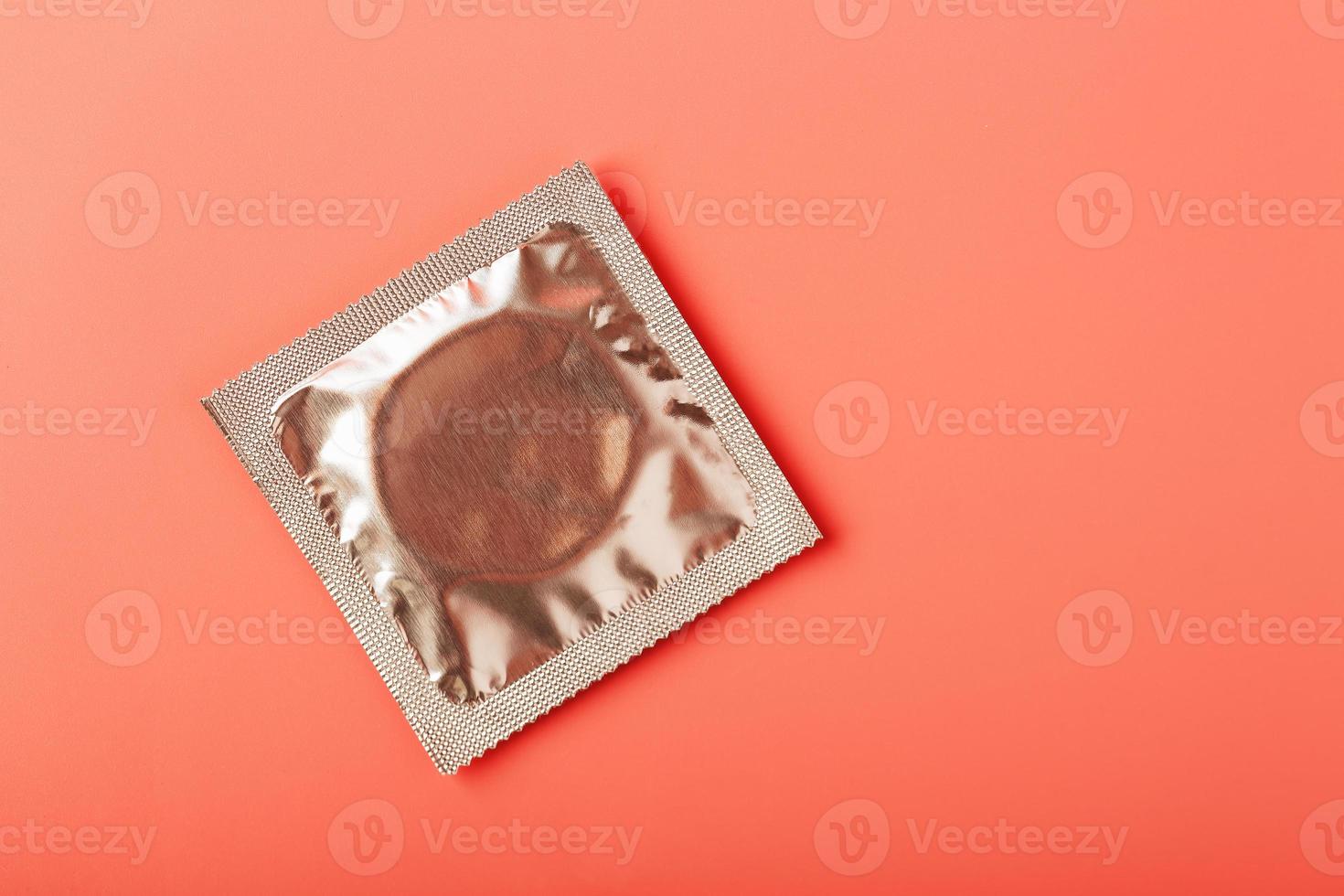 packade kondom på en rosa bakgrund, närbild, topp se. foto
