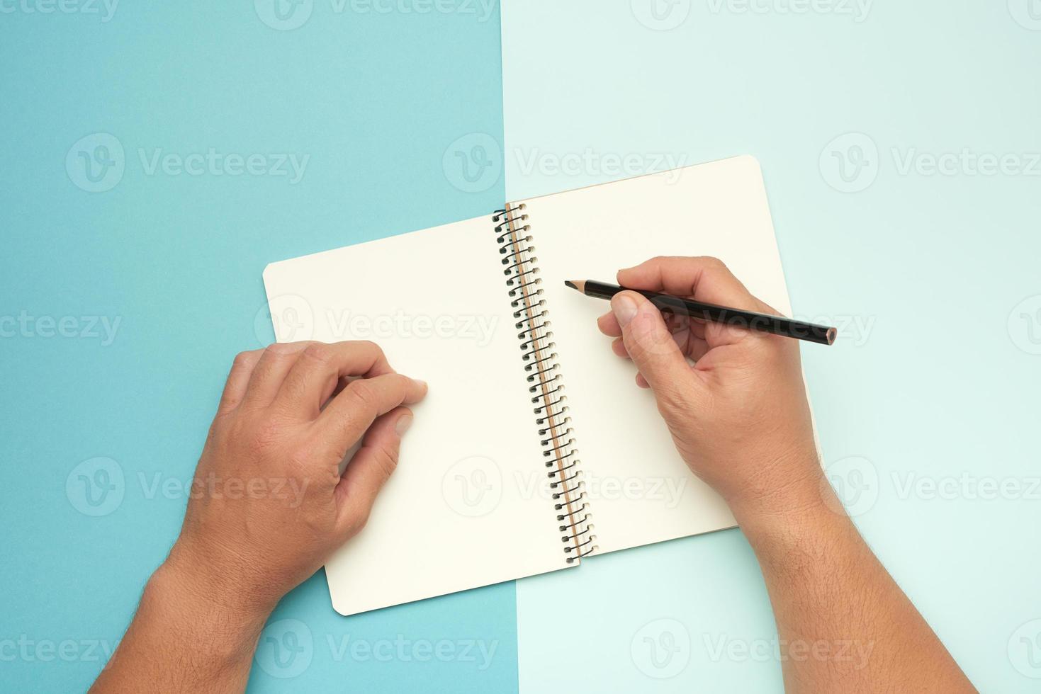 två manlig händer innehav öppen anteckningsblock med tömma vit ark foto