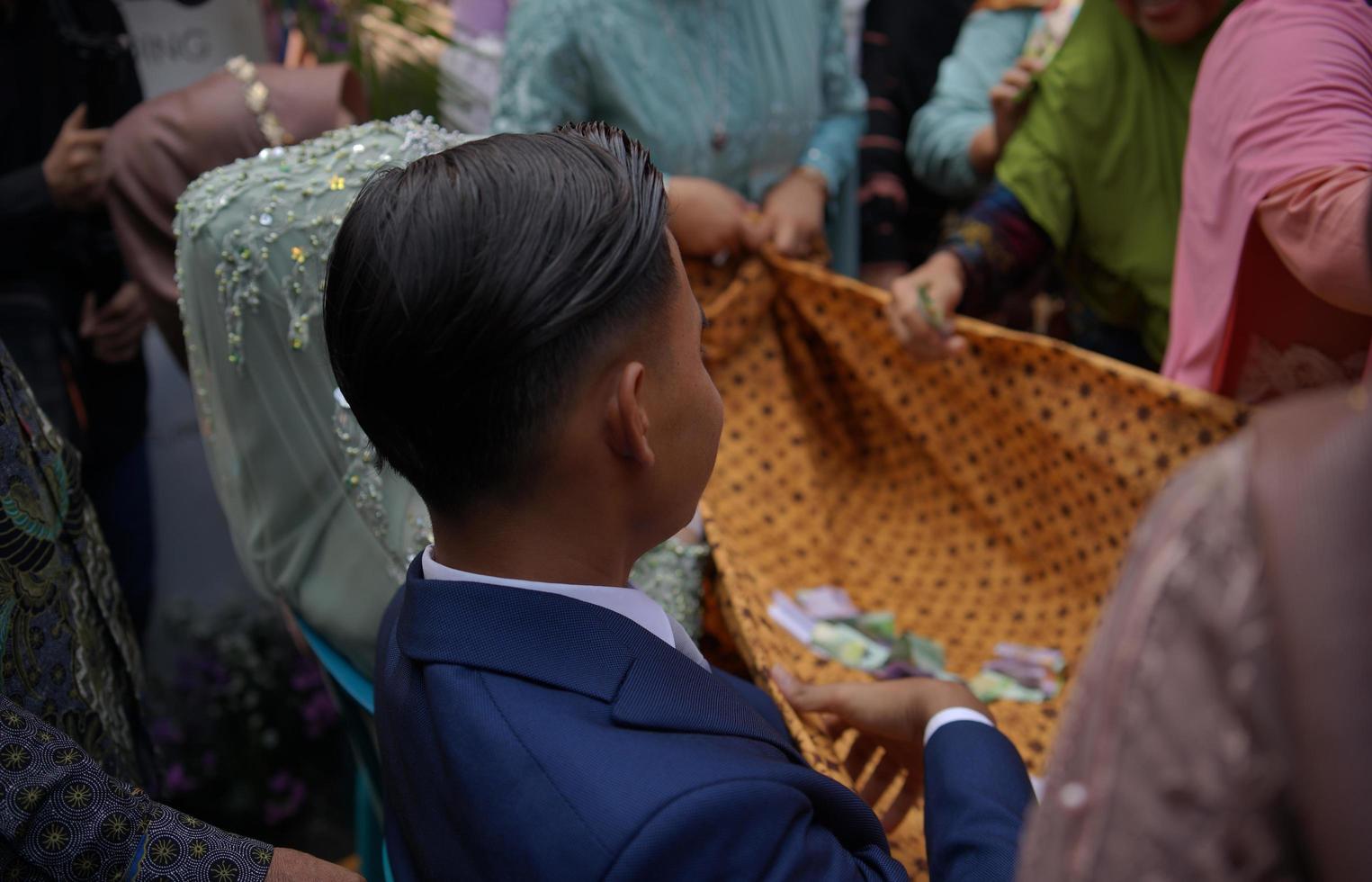 brudgum framställning för en traditionell bröllop ceremoni i indonesien foto