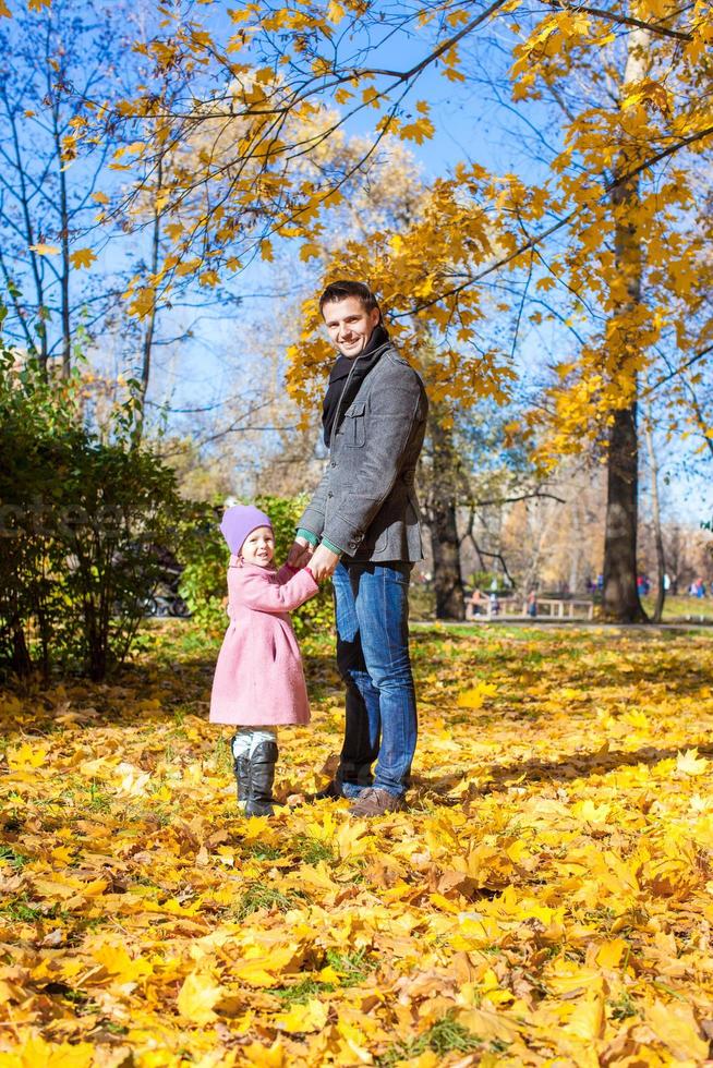 ung far och liten flicka njut av semester i höst parkera foto