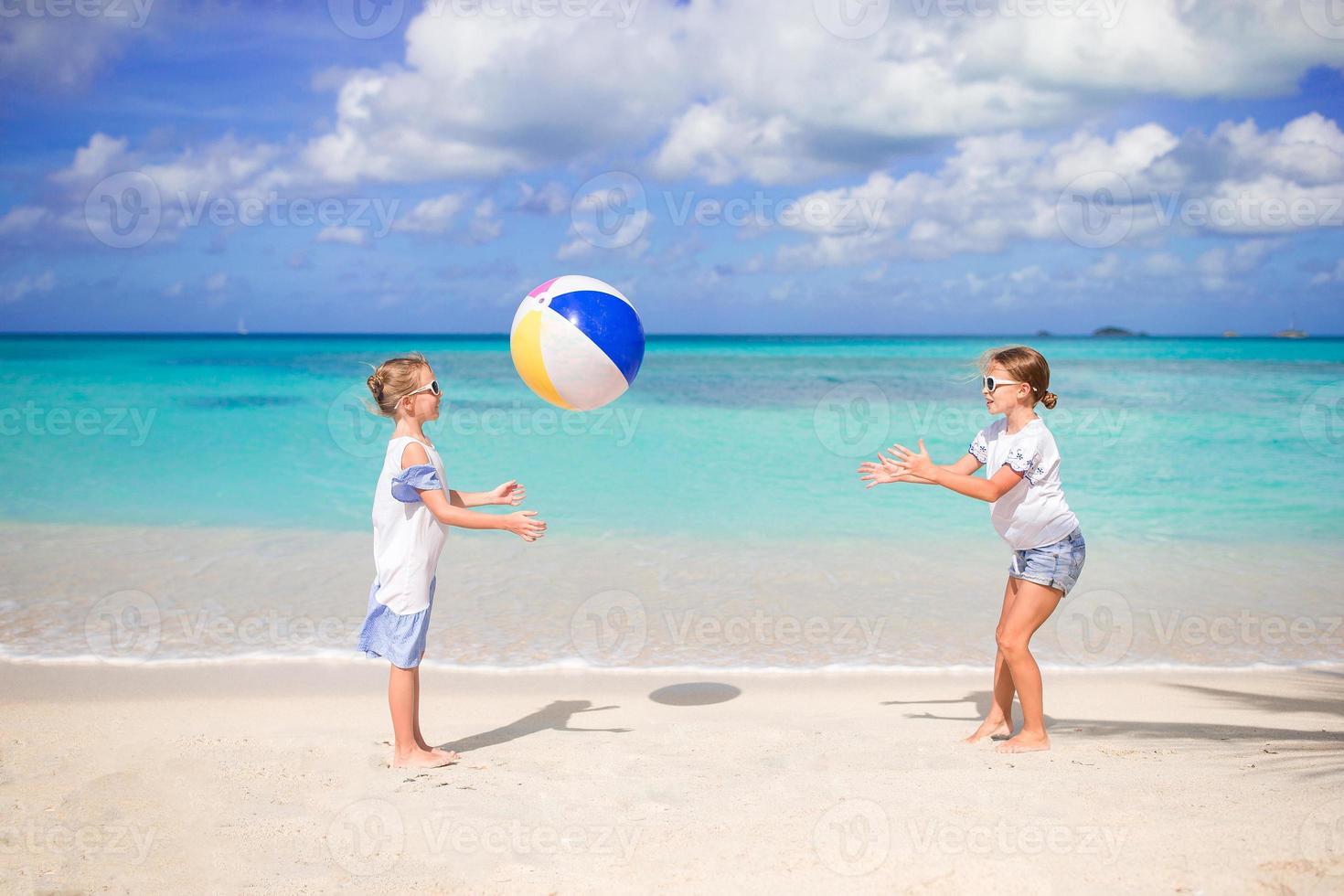 liten förtjusande flickor spelar med boll på de strand foto