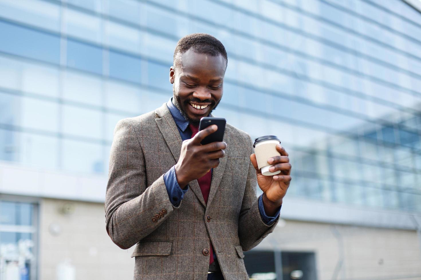 man med en kaffeläsning på sin telefon foto