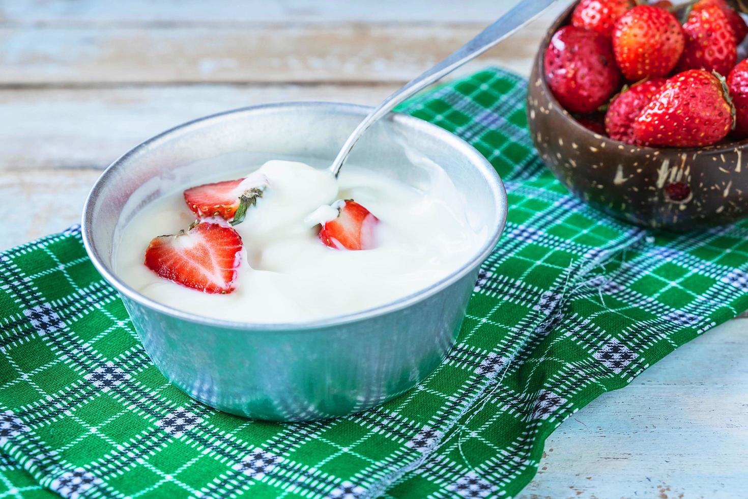 skål med yoghurt med jordgubbar i den foto