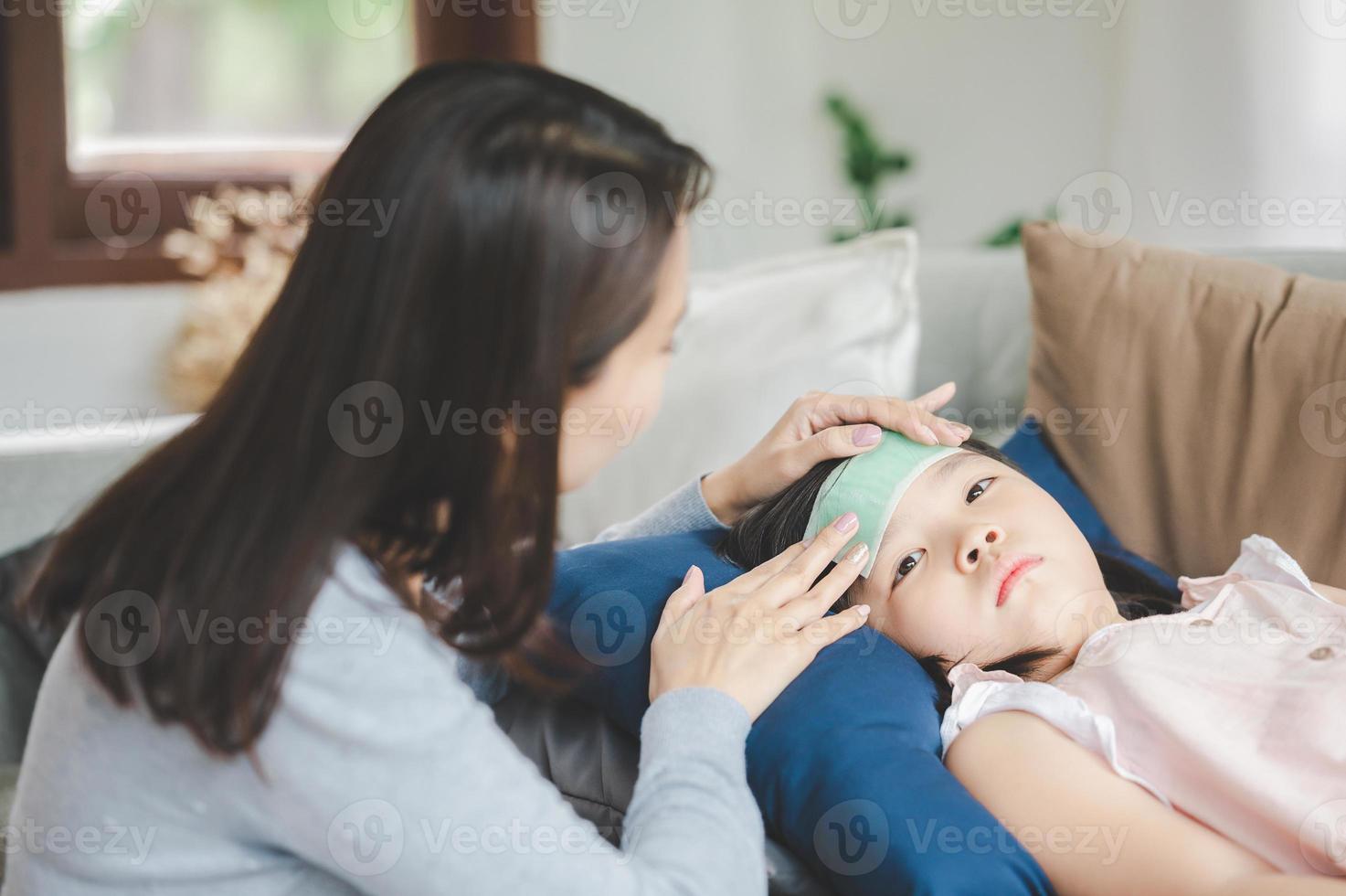 asain mor tar vård för sjuk dotter foto