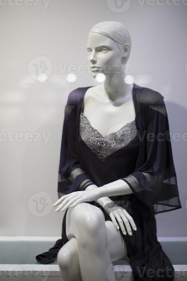 skön kvinna mannekäng i underkläder i en affär fönster. foto