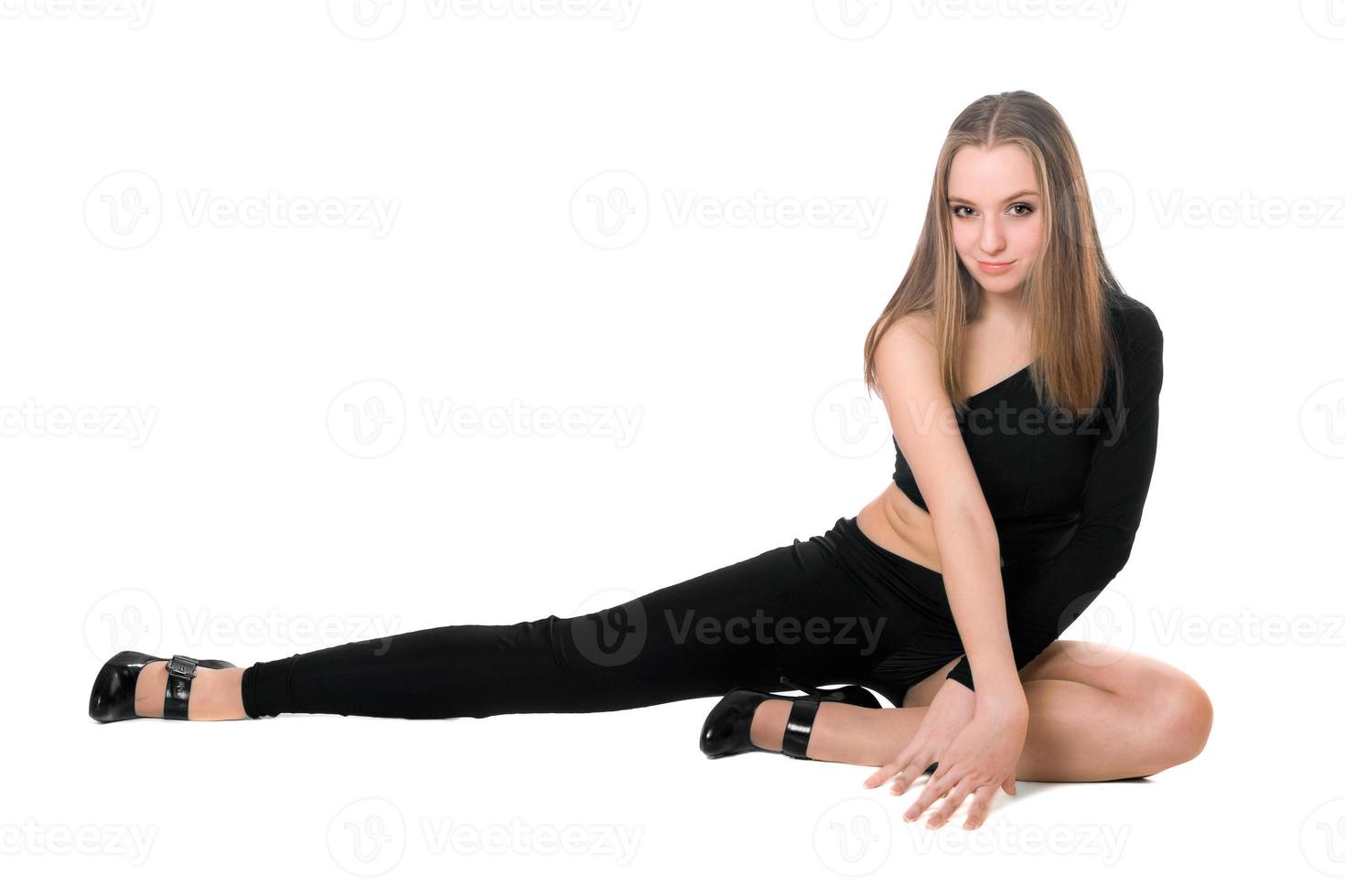 lekfull leggy flicka i en svart TÄTSITTANDE kropp kostym dansa foto