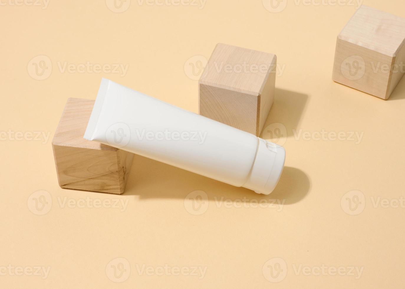 tömma vit plast rör för kosmetika på en vit tabell. förpackning för grädde, gel, serum, reklam och produkt befordran foto