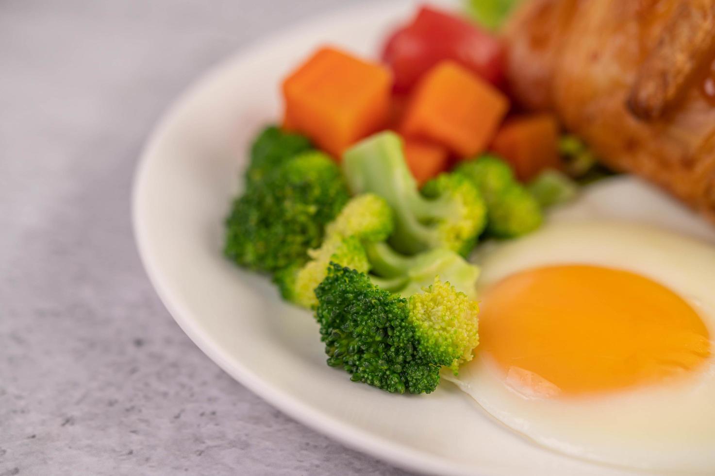 färsk äggcroissant och grönsaksfrukost foto