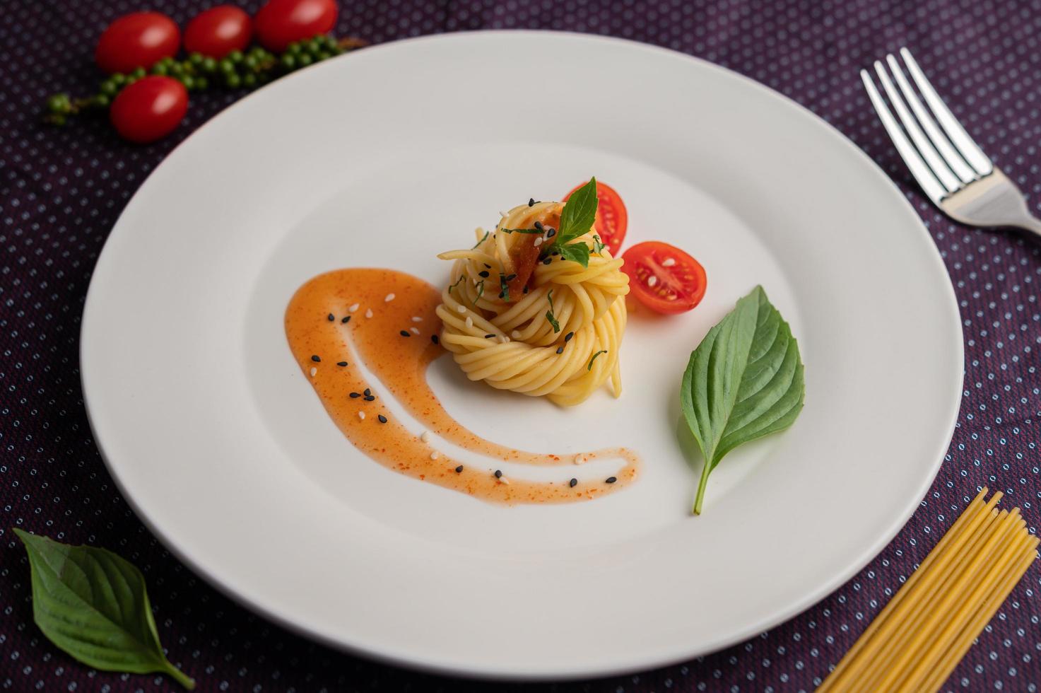 gourmetspaghetti ordnat vackert på en vit tallrik foto