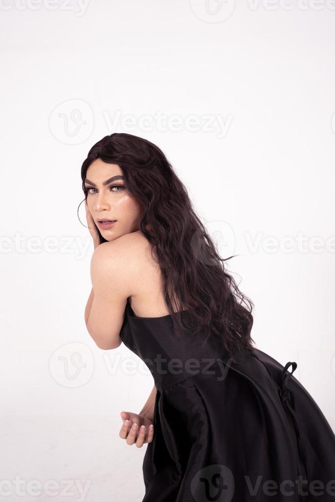 skön asiatisk kvinna med mörk brun hår poserade i en svart klänning foto