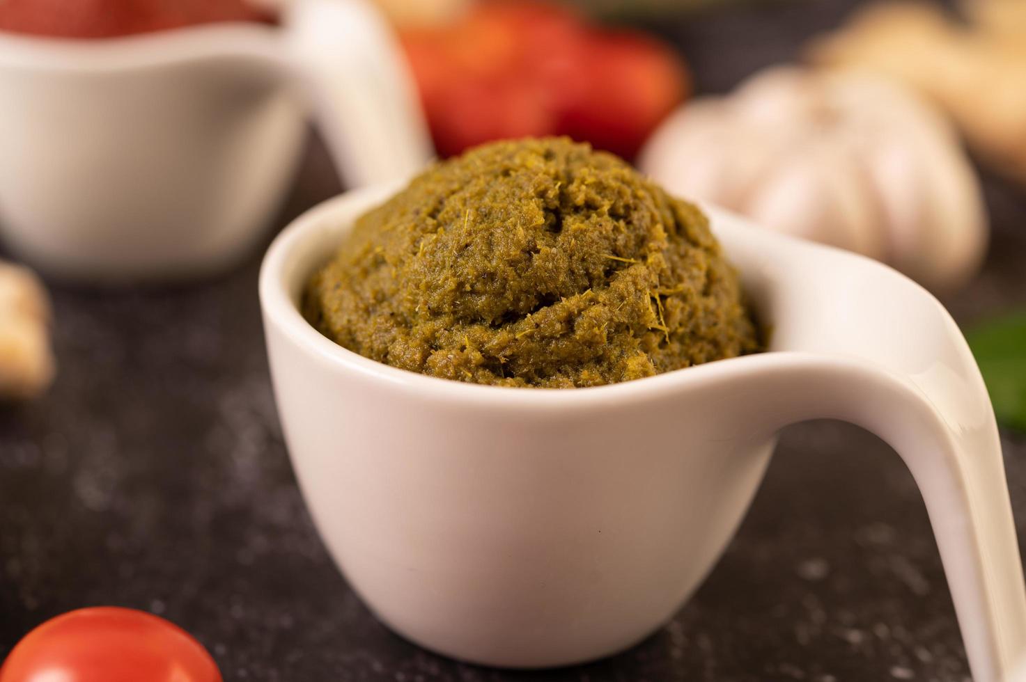 grön currypasta i en vit keramisk kopp foto